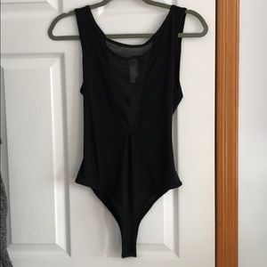 Deep V black body suit.